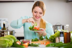 Uma mulher demonstrando como Incluir mais vegetais na sua alimentação
