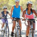 Um homem e duas mulheres demonstrando como os 10 benefícios de andar de bicicleta promovem boa saúde