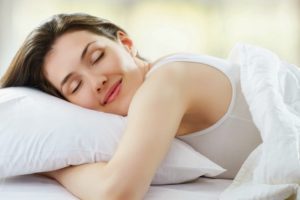 Uma mulher dormindo de pois de aprender dicas para dormir melhor